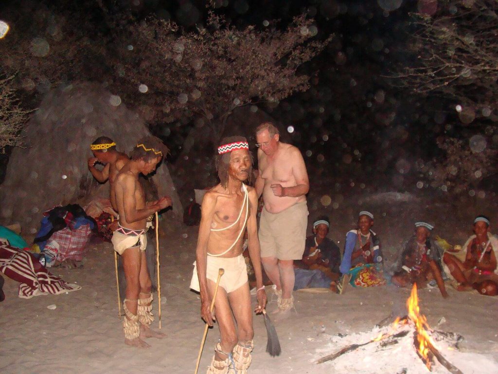 Trance dance at Dquae  Quare Game Park– from left shamans 			Xhara, Qam and Tiger, and Adam(Xhara blowing away poison)